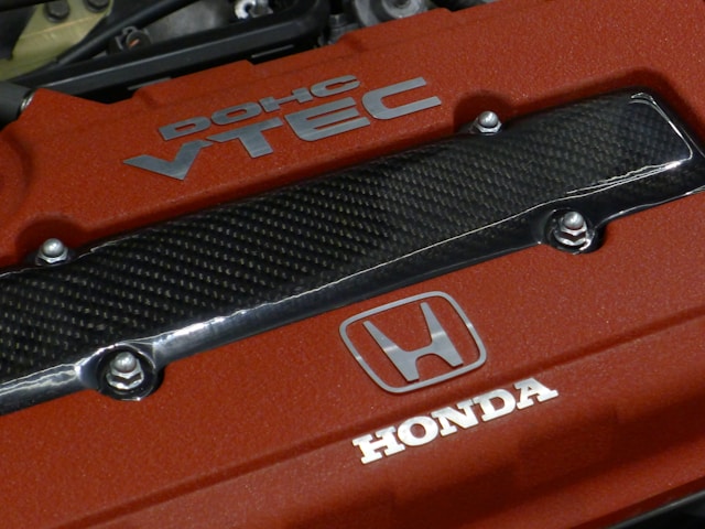 a-close-up-of-the-hood-of-a-red-car